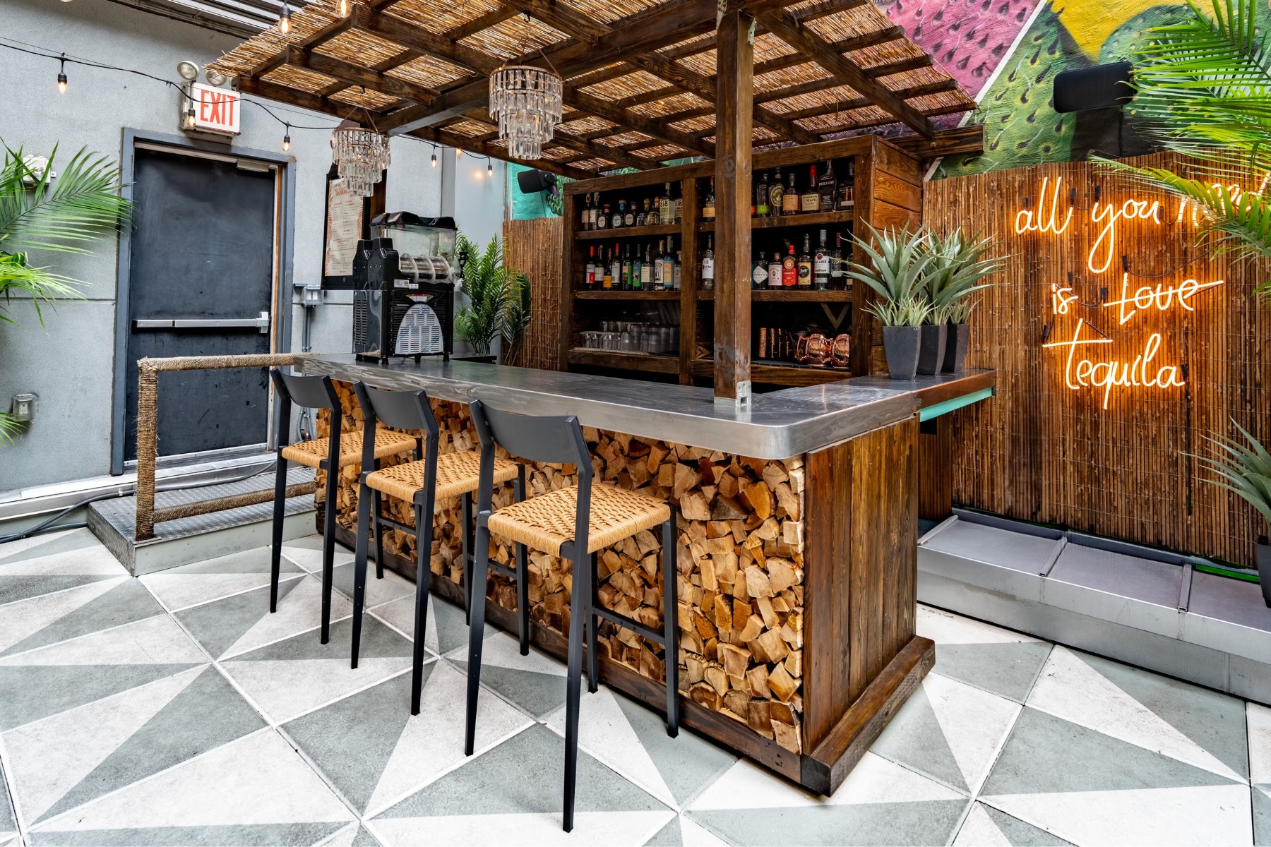Row of commercial metal bar stools with upholstered seats at a restaurant bar counter showing proper seat height and spacing