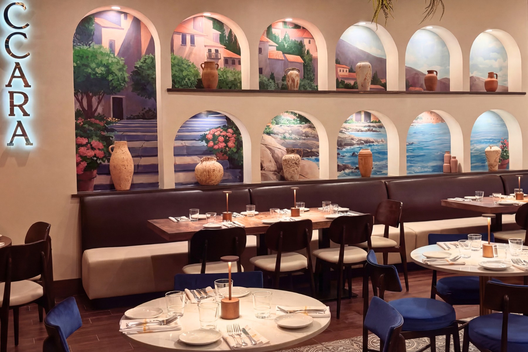 Full-service Italian restaurant dining room with warm wood tables, upholstered chairs, and leather banquette seating along a brick accent wall