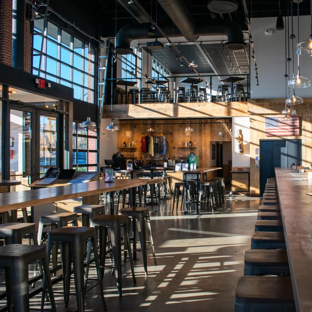 Industrial-style restaurant furniture in Garvies Point Brewery dining area, Long Island