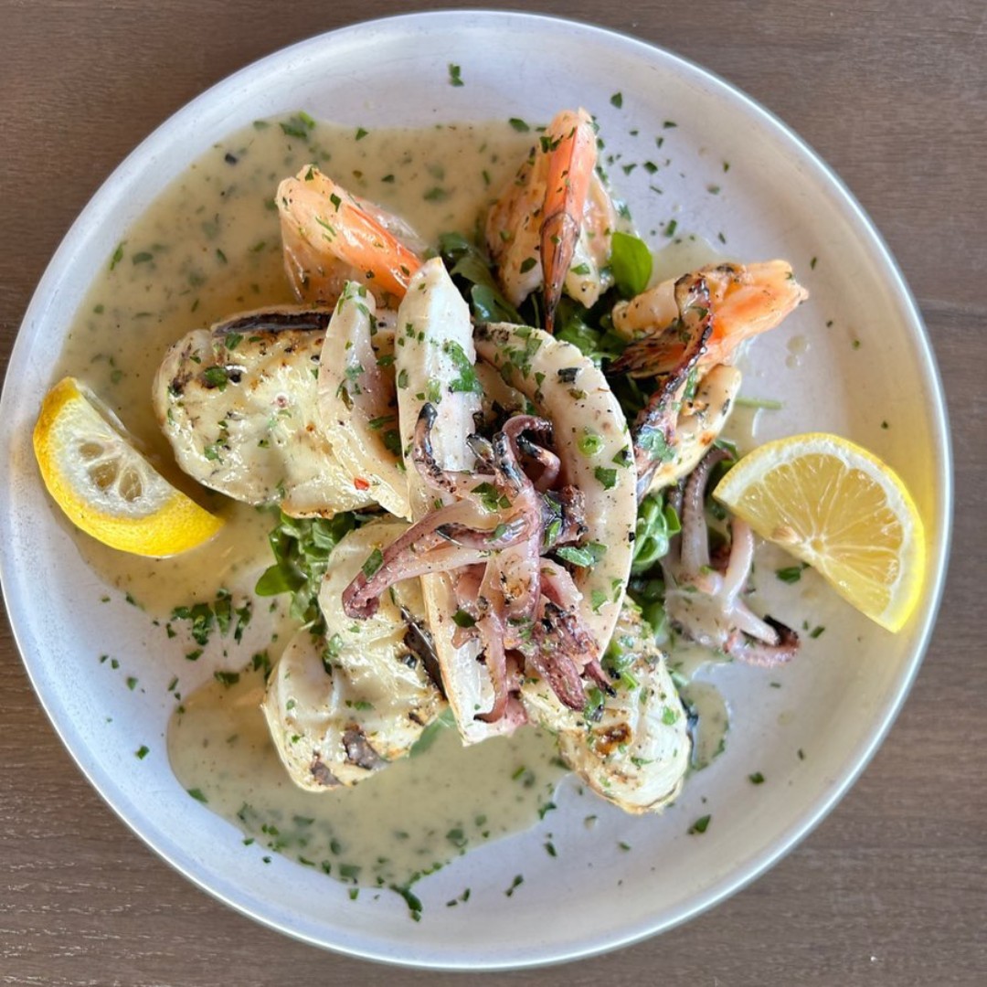 Traditional Italian clam soup served in custom furnished dining setting